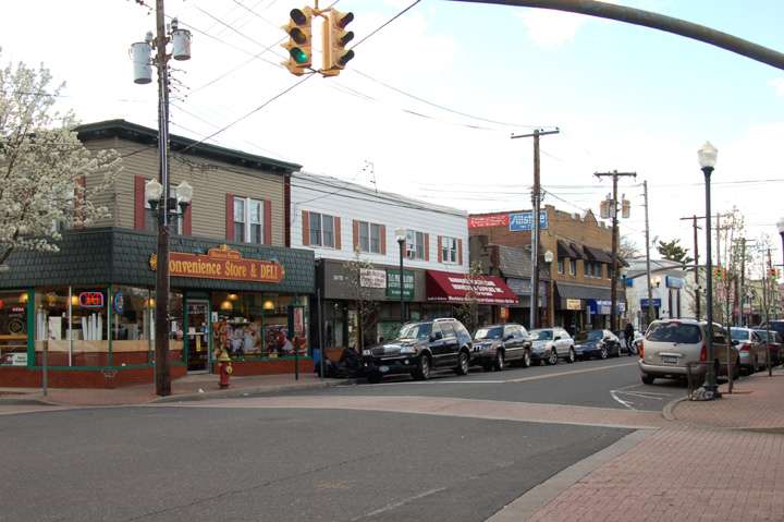 Small town street with shops and parked cars