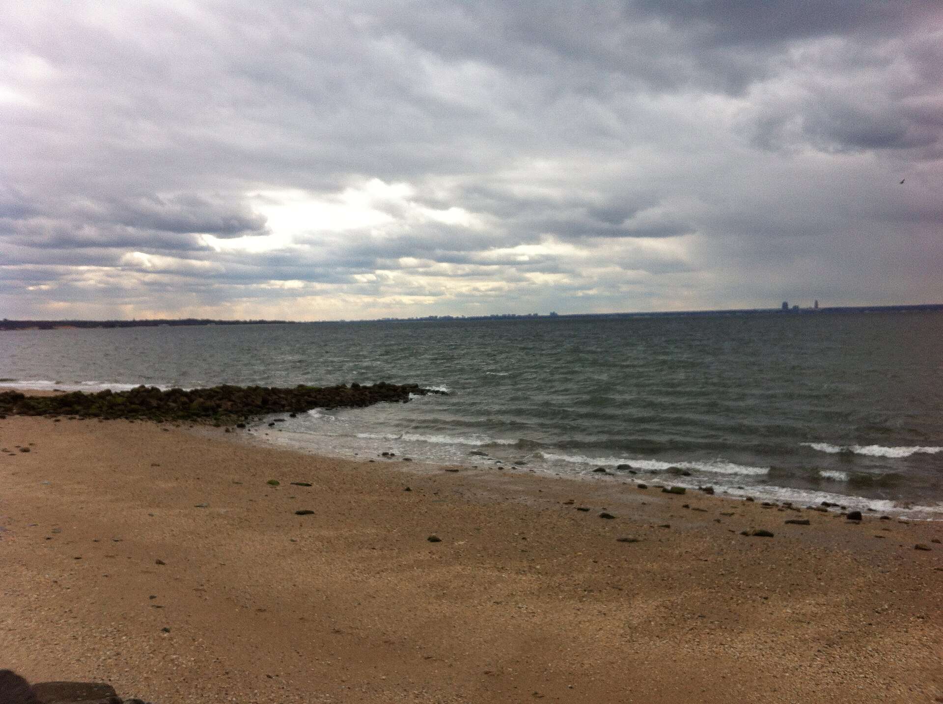 Cloudy sky over a rocky beach shoreline
