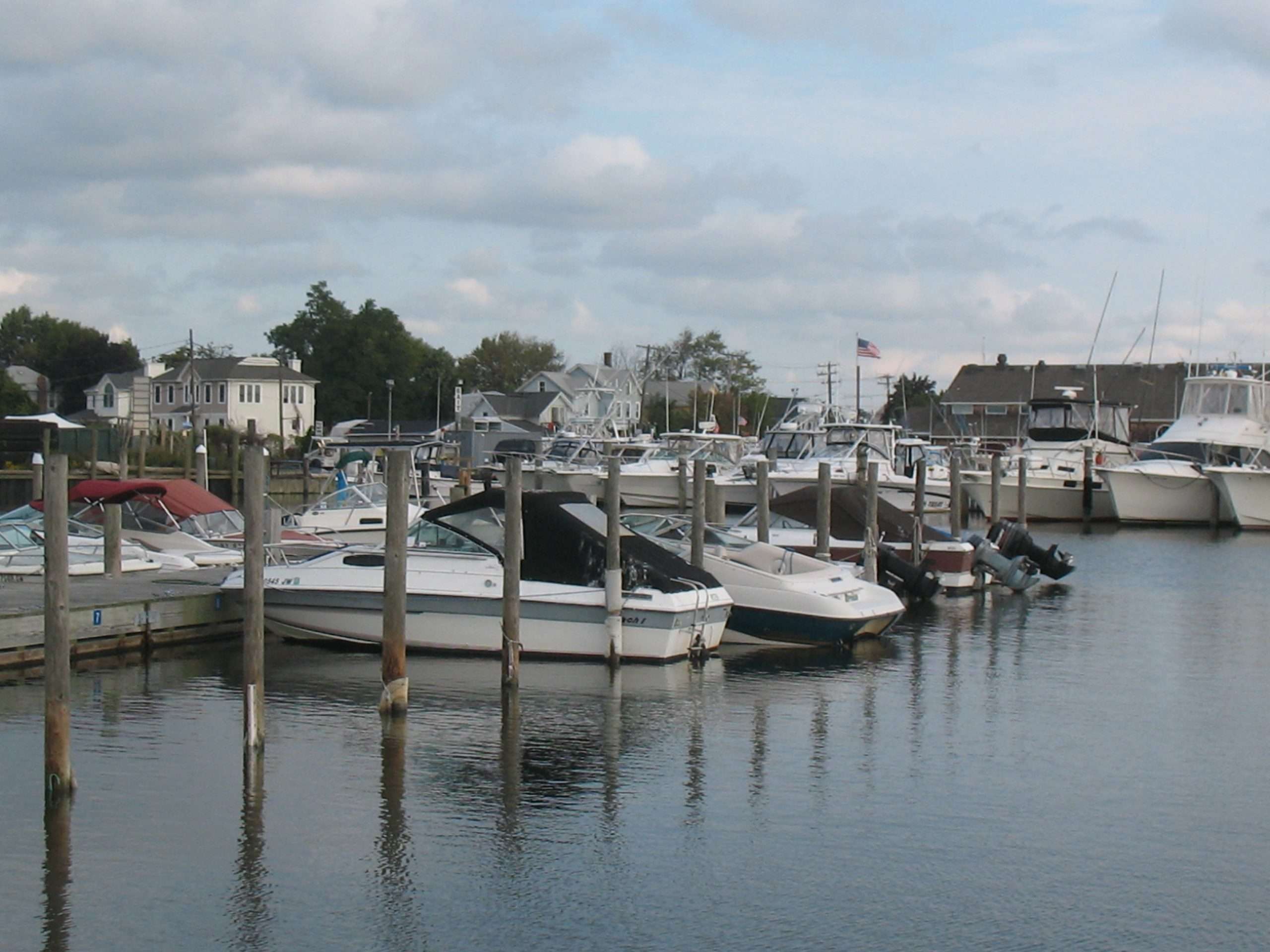 Boats docked at a marina on a cloudy day