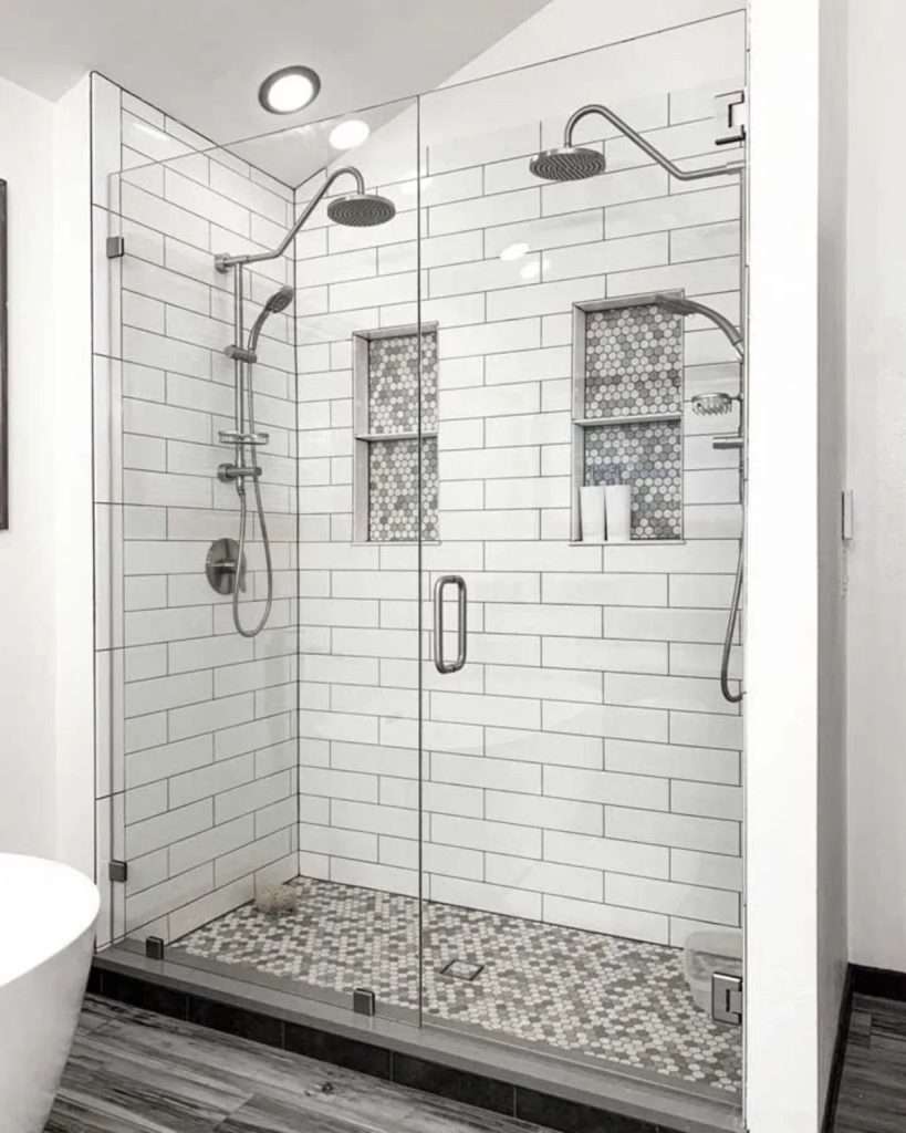 Modern glass shower with dual showerheads and tile walls