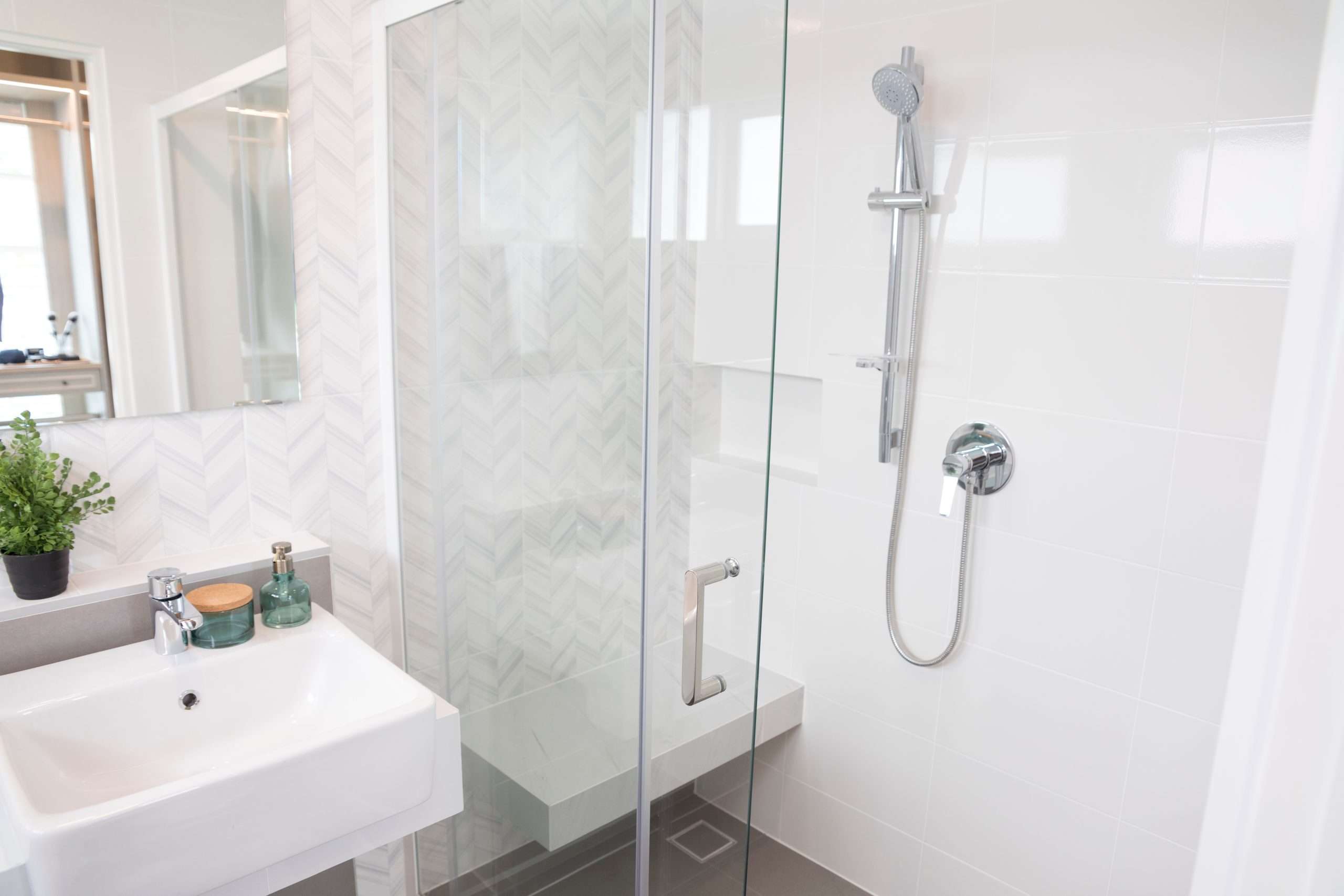 Modern bathroom with glass shower and white sink