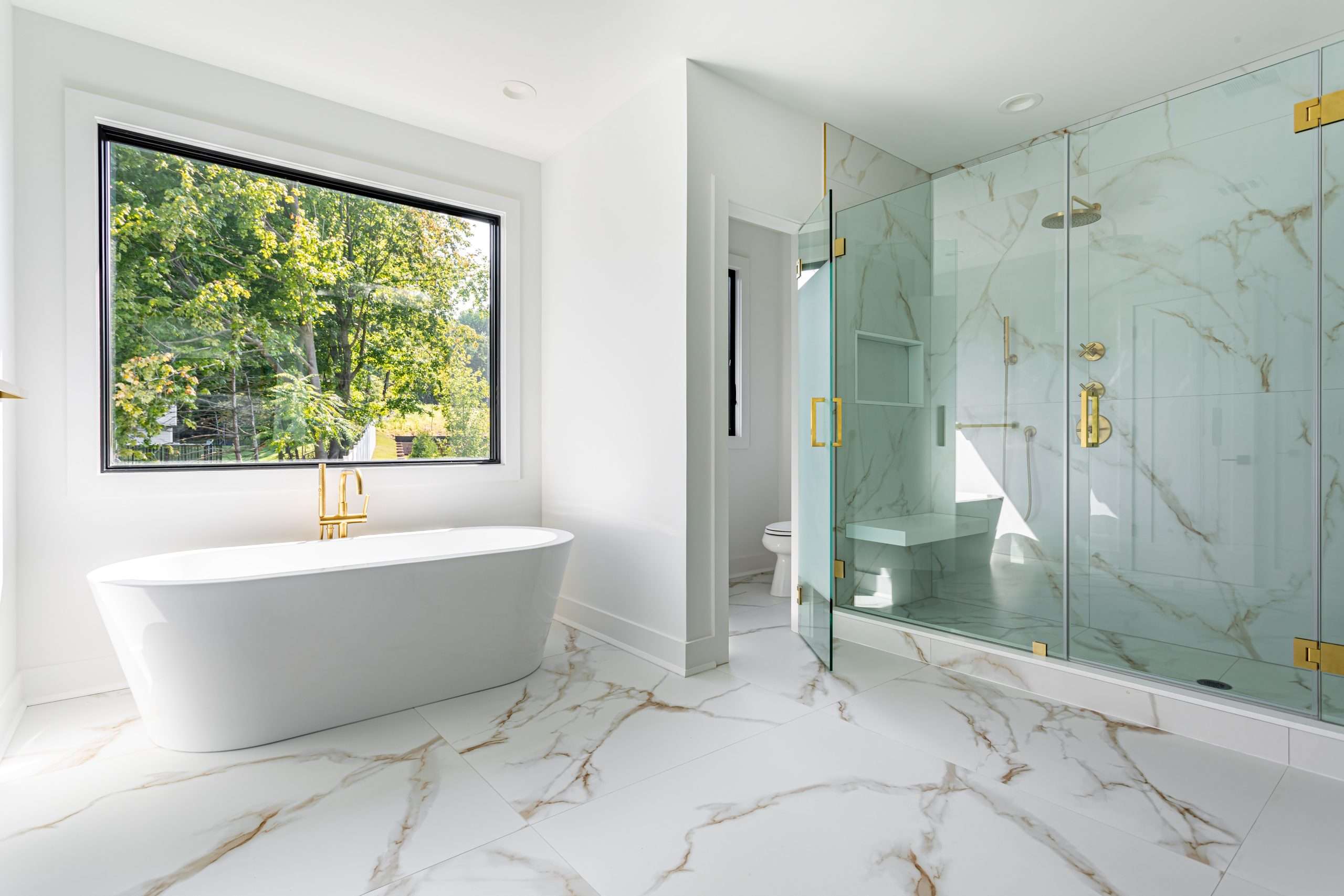 modern bathroom interior with freestanding bathtub and glass walk in shower